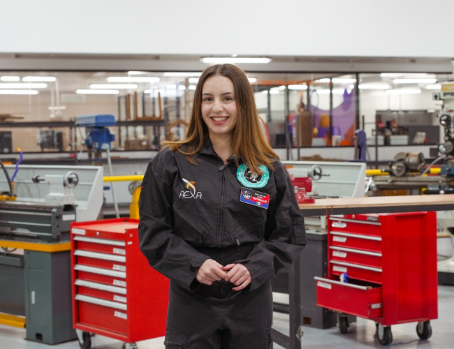 Estudiante de Anáhuac Querétaro Majo Lira de la carrera de mecanica con traje de programa AEXA en un taller de mecánica